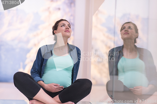 Image of pregnant women sitting on the floor