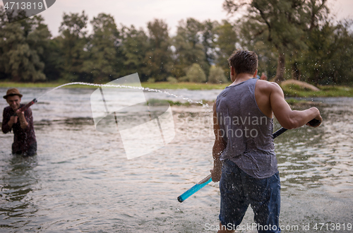 Image of young men having fun with water guns