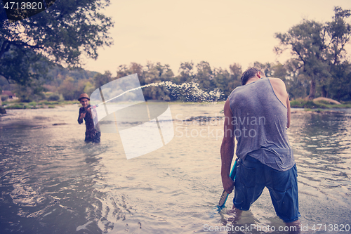 Image of young men having fun with water guns