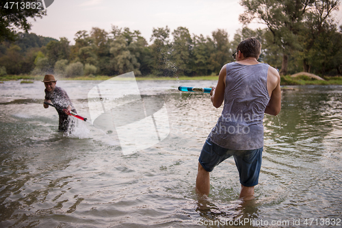 Image of young men having fun with water guns