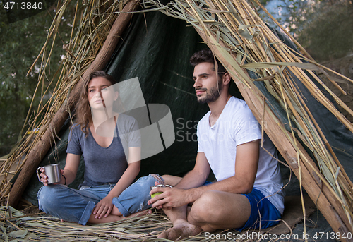 Image of couple spending time together in straw tent