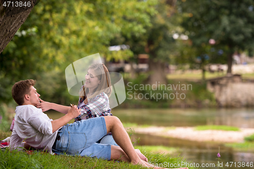 Image of Couple in love enjoying picnic time