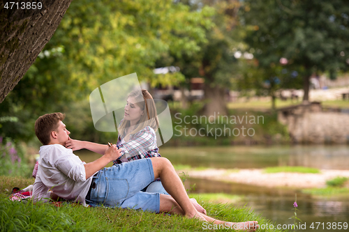 Image of Couple in love enjoying picnic time