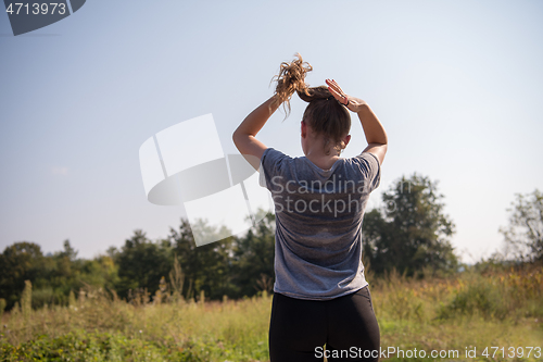 Image of woman jogging along a country road