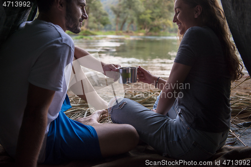 Image of couple spending time together in straw tent