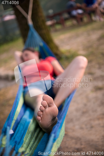 Image of woman resting on hammock