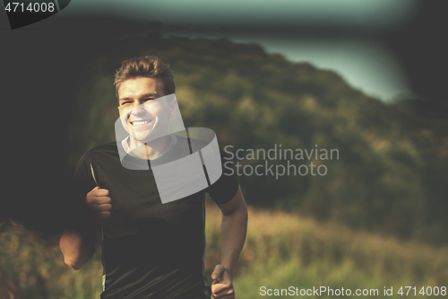 Image of man jogging along a country road