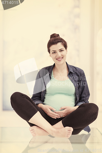 Image of pregnant women sitting on the floor
