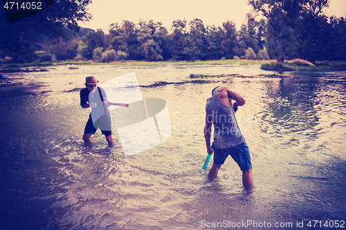 Image of young men having fun with water guns