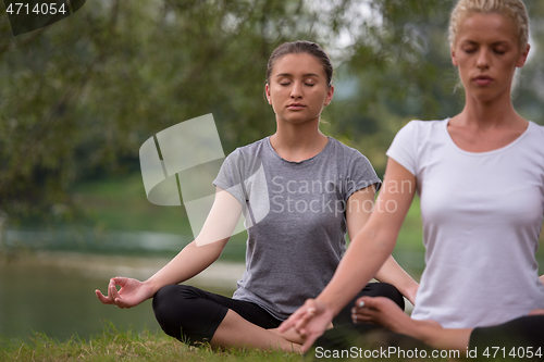 Image of women meditating and doing yoga exercise