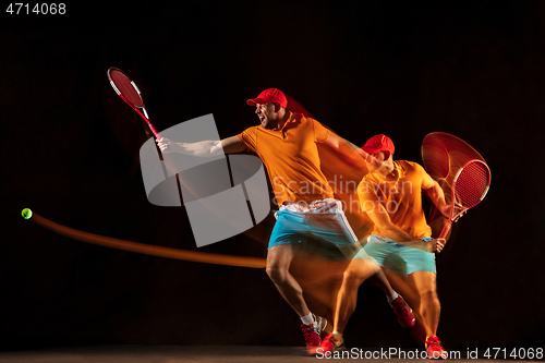 Image of One caucasian man playing tennis on black background