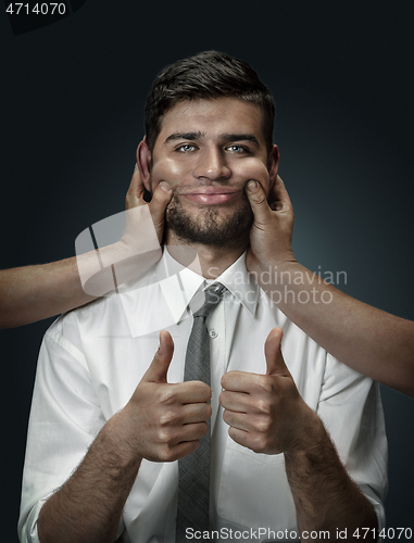 Image of A young man surrounded by hands like his own thoughts