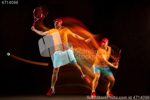 Image of One caucasian man playing tennis on black background