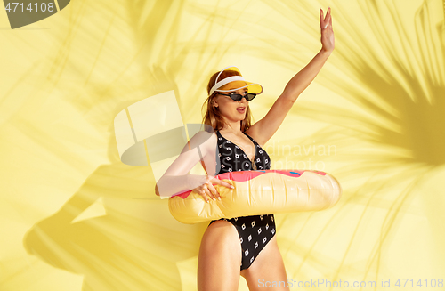 Image of Beautiful girl isolated on yellow studio background