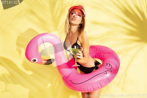 Image of Beautiful girl isolated on yellow studio background