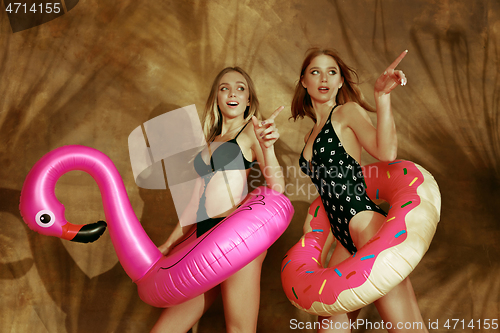 Image of Beautiful girls isolated on braun studio background