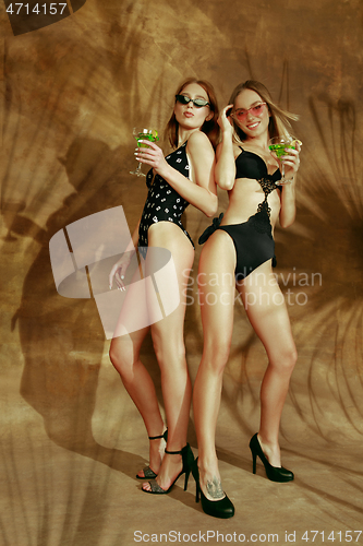 Image of Beautiful girls isolated on braun studio background