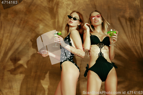 Image of Beautiful girls isolated on braun studio background