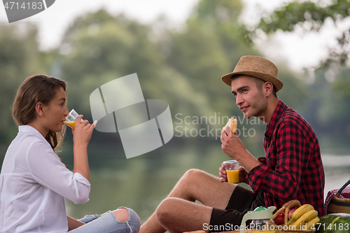 Image of Couple in love enjoying picnic time