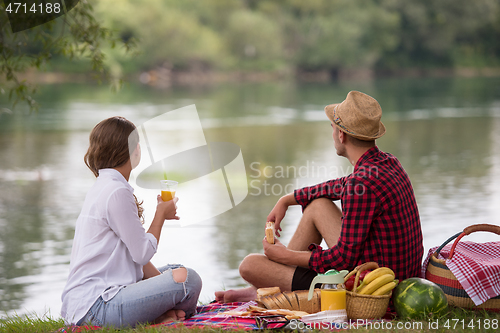 Image of Couple in love enjoying picnic time