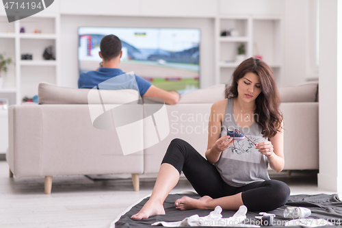 Image of pregnant couple checking a list of things for their unborn baby