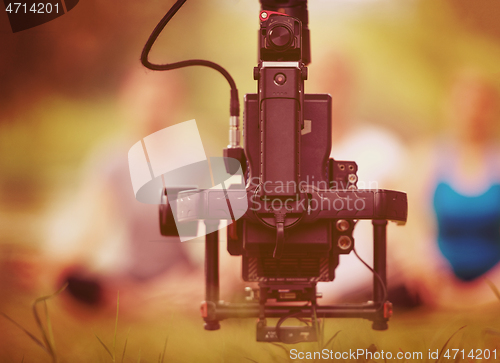 Image of young videographer recording while woman doing yoga exercise