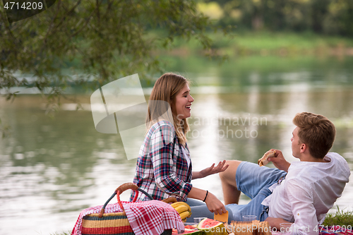 Image of Couple in love enjoying picnic time