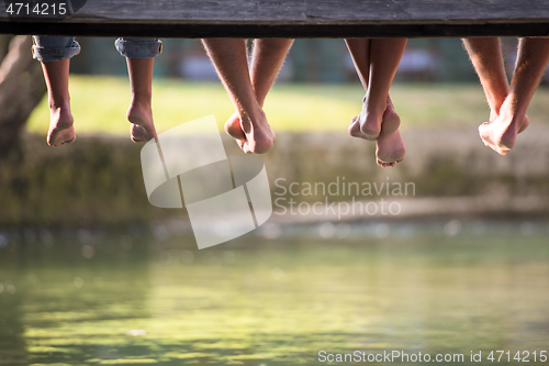 Image of people sitting at wooden bridge