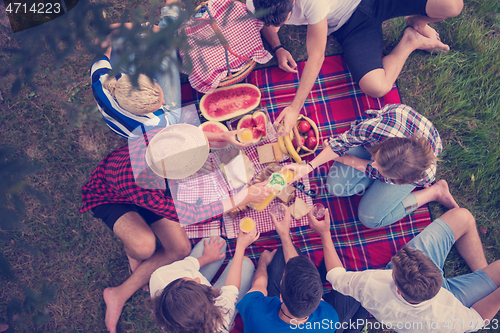 Image of top view of group friends enjoying picnic time