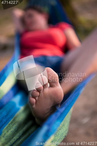 Image of woman resting on hammock