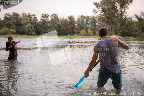 Image of young men having fun with water guns