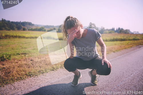 Image of woman jogging along a country road
