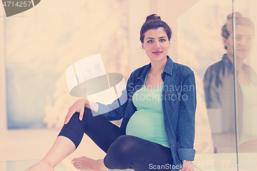 Image of pregnant women sitting on the floor