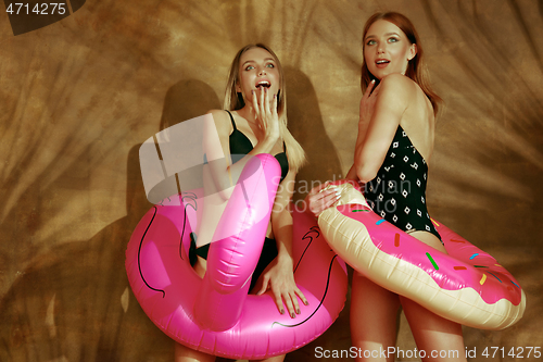 Image of Beautiful girls isolated on braun studio background