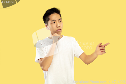 Image of Korean young man\'s half-length portrait on yellow background