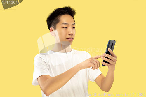 Image of Korean young man\'s half-length portrait on yellow background