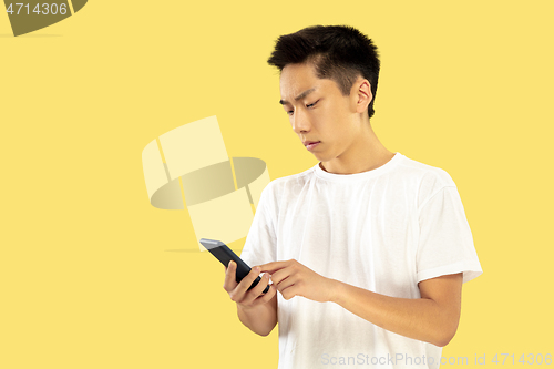 Image of Korean young man\'s half-length portrait on yellow background