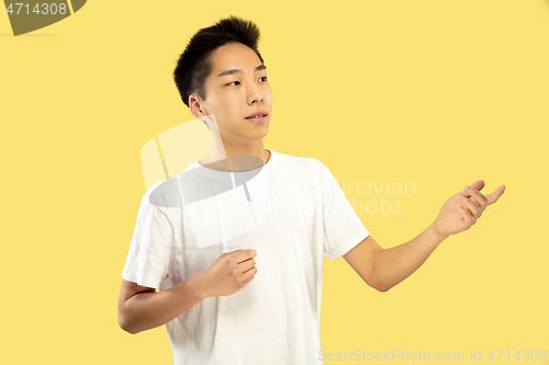 Image of Korean young man\'s half-length portrait on yellow background