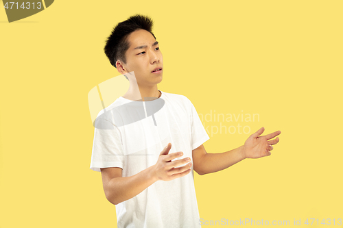 Image of Korean young man\'s half-length portrait on yellow background