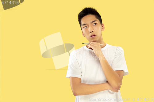 Image of Korean young man\'s half-length portrait on yellow background