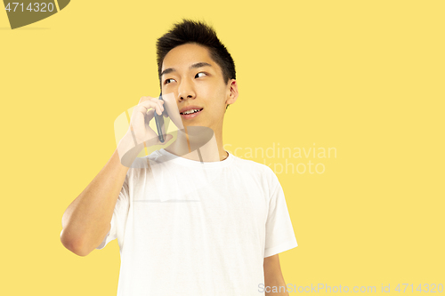 Image of Korean young man\'s half-length portrait on yellow background