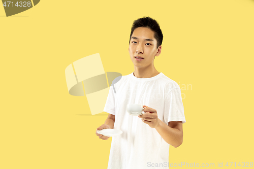 Image of Korean young man\'s half-length portrait on yellow background