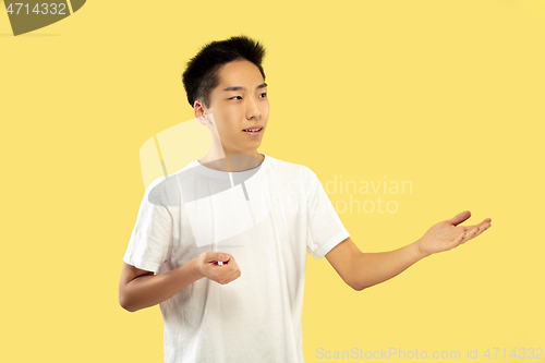 Image of Korean young man\'s half-length portrait on yellow background