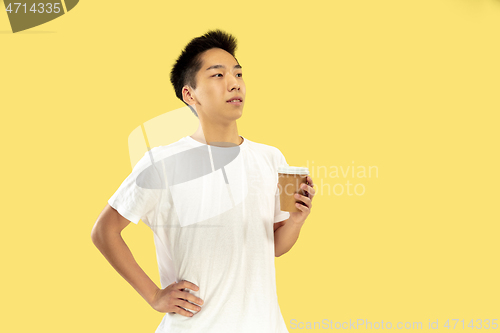 Image of Korean young man\'s half-length portrait on yellow background