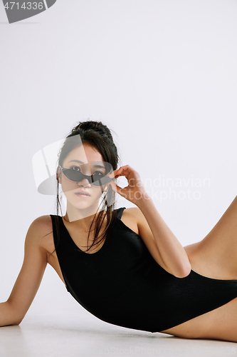 Image of Young female ballet dancer against white studio background