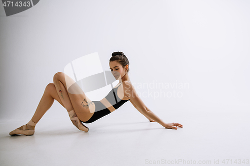 Image of Young female ballet dancer against white studio background