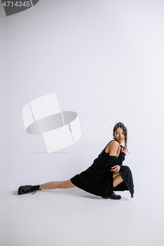 Image of Young female ballet dancer against white studio background