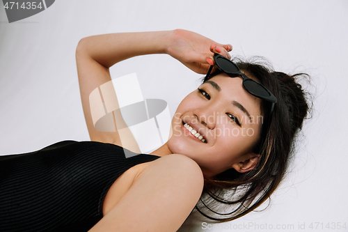 Image of Young female ballet dancer against white studio background