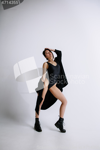 Image of Young female ballet dancer against white studio background