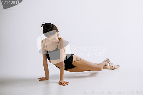 Image of Young female ballet dancer against white studio background